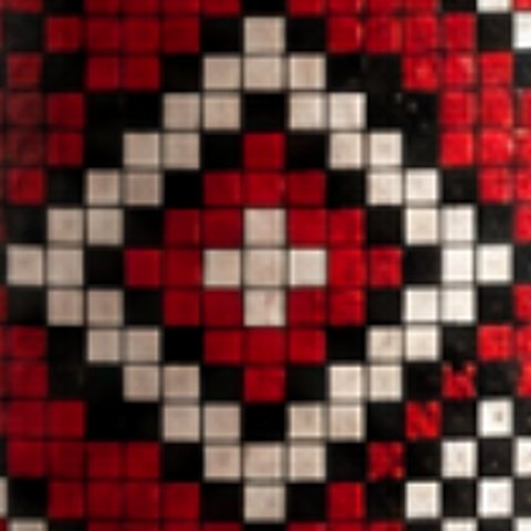 Seythur's mark: a red, black and bone cross-stitch diamond